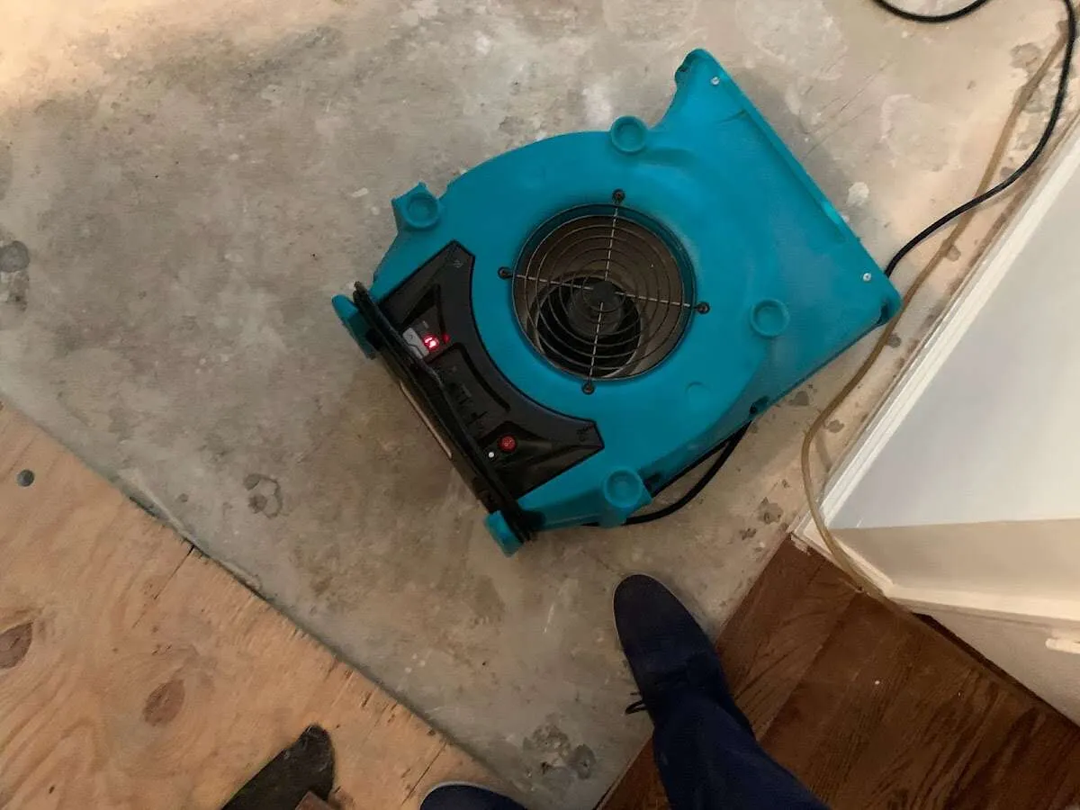 Air mover drying subfloor during Commercial Water Damage Restoration in Tanaina
